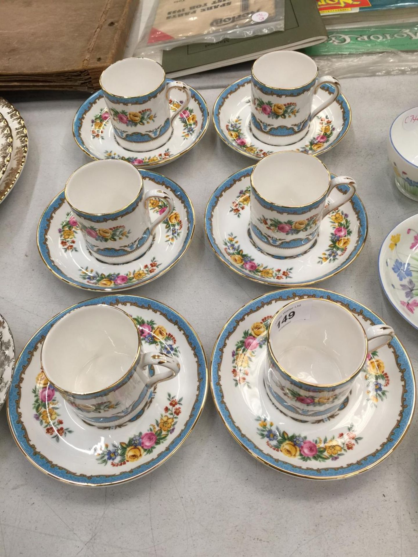 A SET OF SIX CROWN STAFFORDSHIRE CHINA DEMI-TASSE COFFEE CANS AND SAUCERS WITH A FLORAL PATTERN