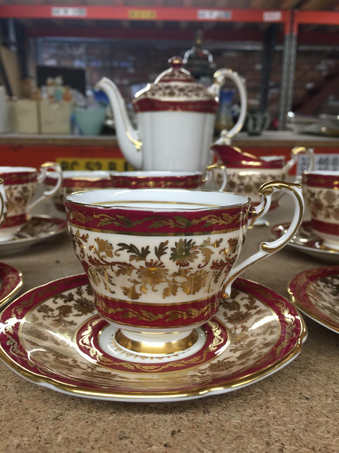 A PARAGON CHINA COFFEE SET IN A CRIMSON AND GILT PATTERN TO INCLUDE A COFFEE POT, CREAM JUG, SUGAR - Image 3 of 4