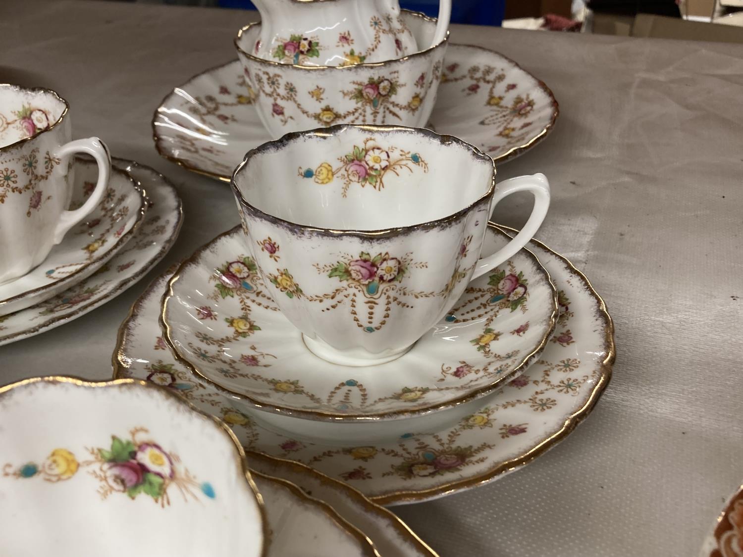 A 'MICHAEL' CHINA TEASET WITH FLORAL SWAG DESIGN TO INCLUDE CAKE PLATE CREAM JUG, SUGAR BOWL, - Image 3 of 5