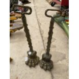 A PAIR OF VINTAGE BRASS COATED LION PAW DOOR STOPS