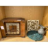 A WOODEN MANTLE CLOCK, TWO TRIVET STANDS AND A JUG