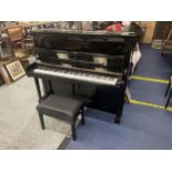 A STEINWAY AND SONS UPRIGHT PIANO - NUMBERED 600732 - BELIEVED MANUFACTURED IN 2015 COSTING IN