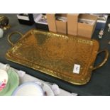 A BEATEN BRASS TWO HANDLED TRAY 39CM X 25CM