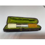A SILVER AND AMBER CHEROOT HOLDER IN A PRESENTATION BOX