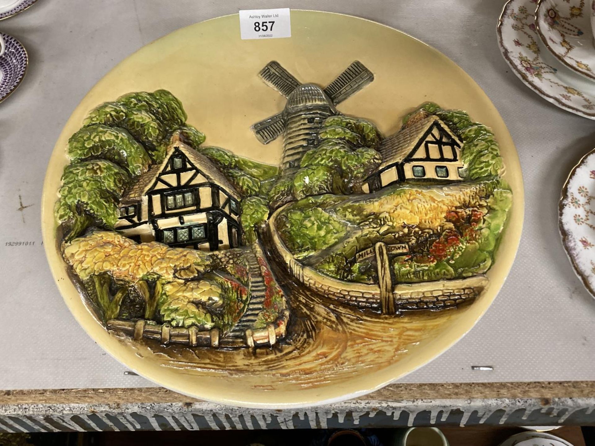 TWO CERAMIC 3-D WALL PLAQUES WITH SCENES OF RURAL VILLAGES - Image 2 of 3