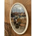 A DECORATIVE WOODEN FRAMED BEVELED EDGE WALL MIRROR