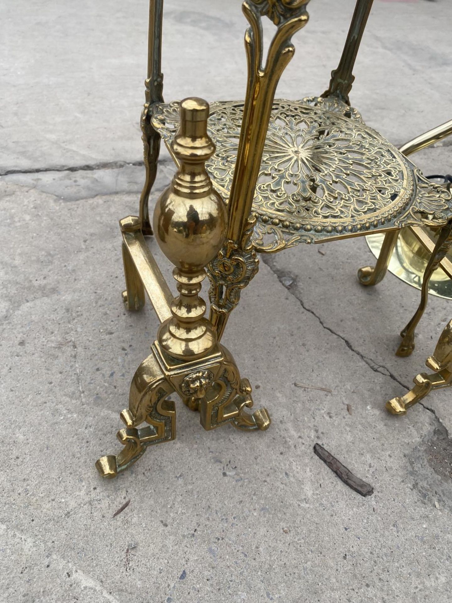 A DECORATIVE BRASS TWO TIER STAND AND A PAIR OF BRASS FIRE DOGS - Image 3 of 4