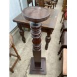 A MAHOGANY TORCHERE WITH TURNED COLUMN AND SQUARE BASE