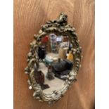 A DECORATIVE GILT FRAMED WALL MIRROR