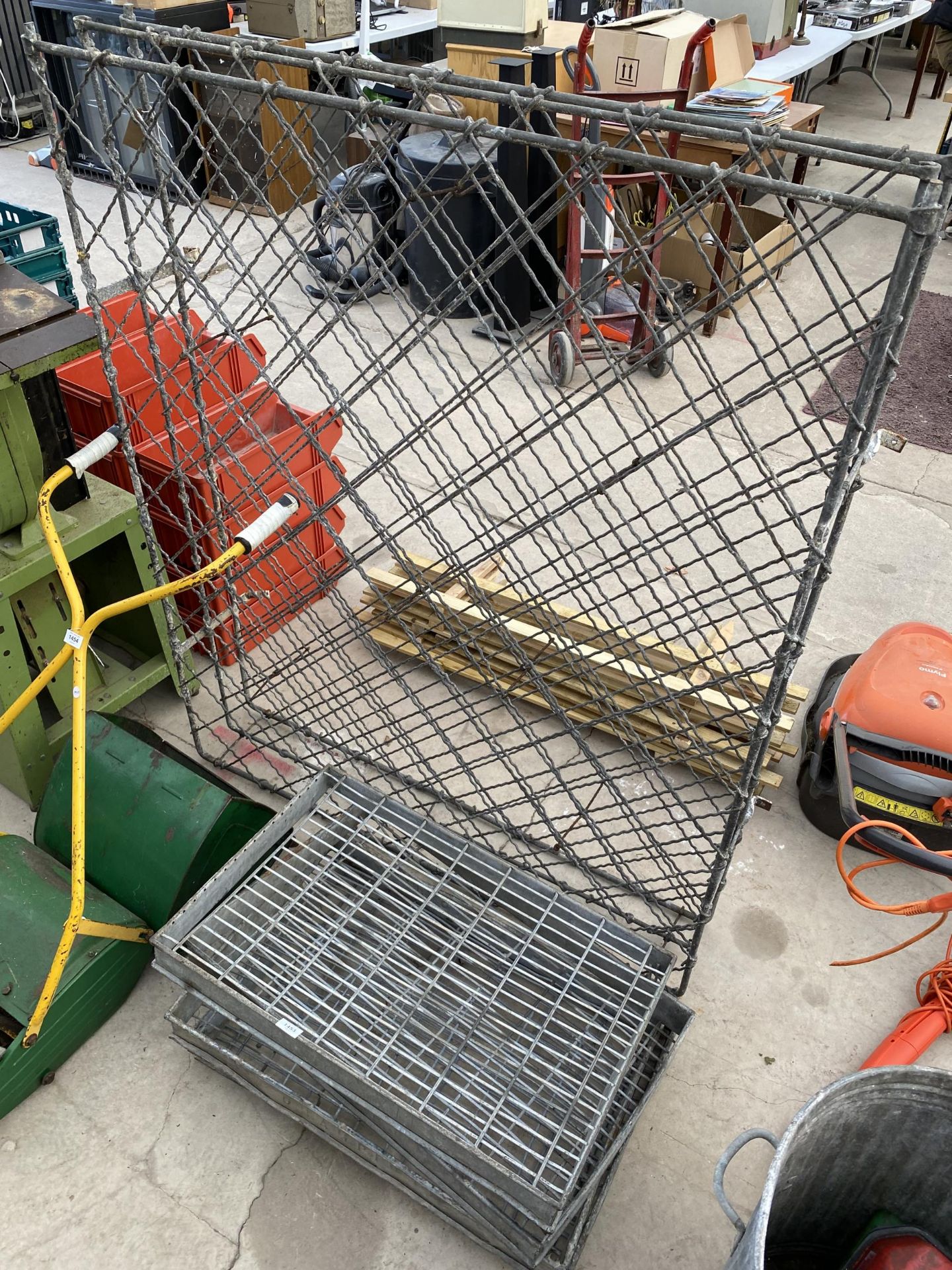 A VINTAGE GALVANISED WINE RACK AND FOUR GALVANISED GRATES