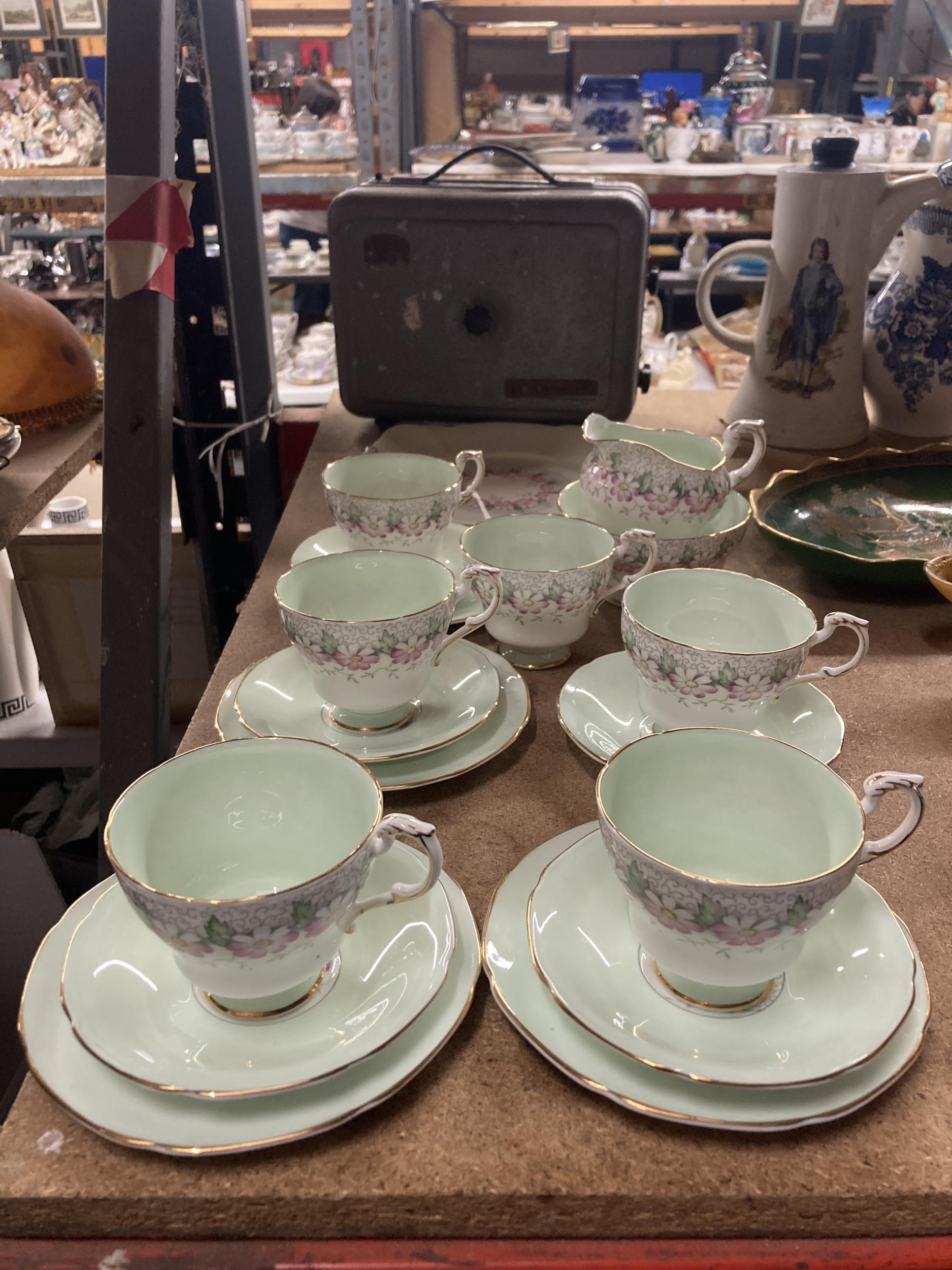 A PARAGON 'MARGOT' CHINA TEASET IN PALE GREEN WITH FLORAL DECORATION TO INCLUDE SUGAR BOWL, CREAM