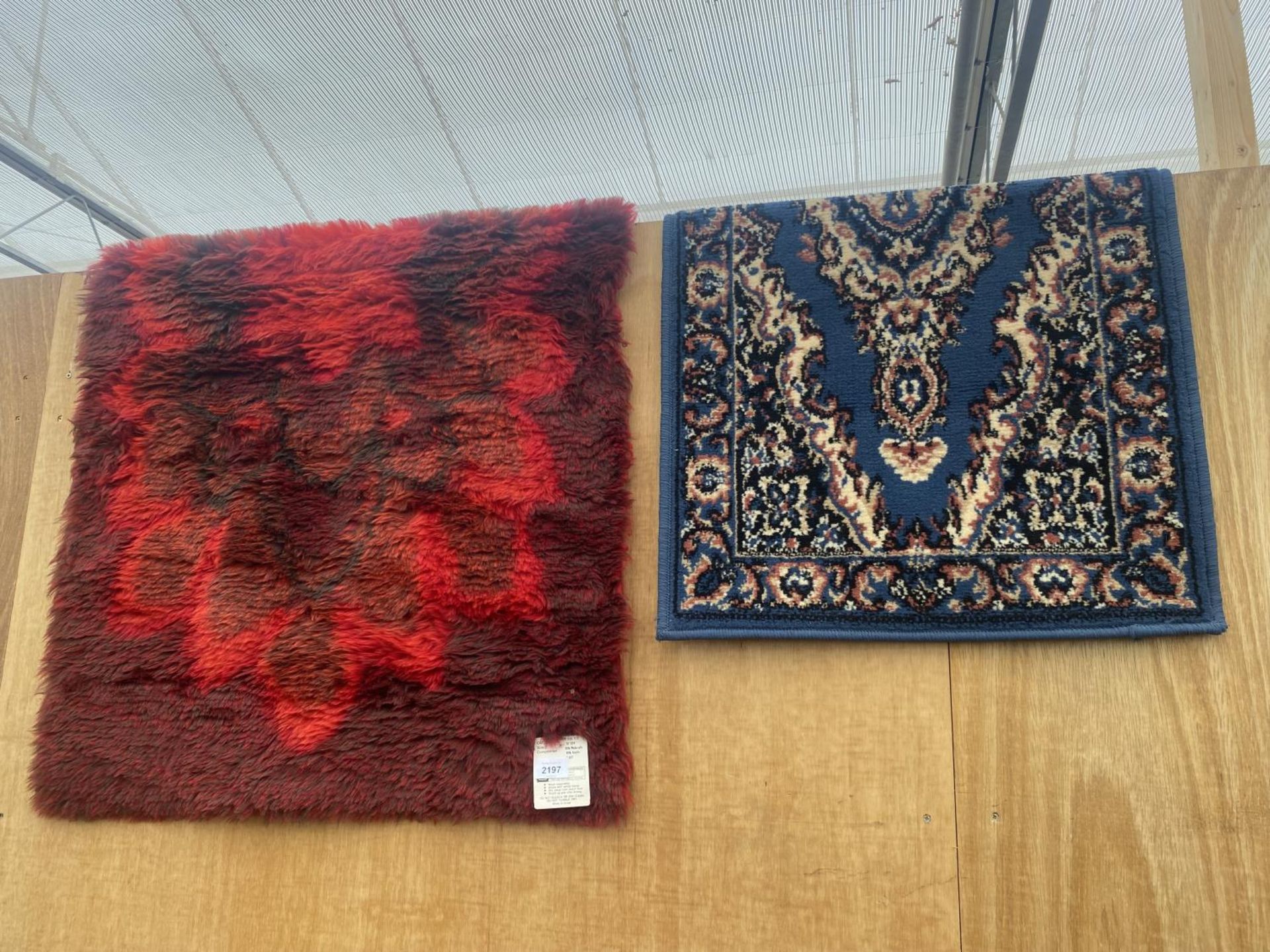 A MODERN RED RUG (30"X54") AND A BLUE PATTERNED RUG