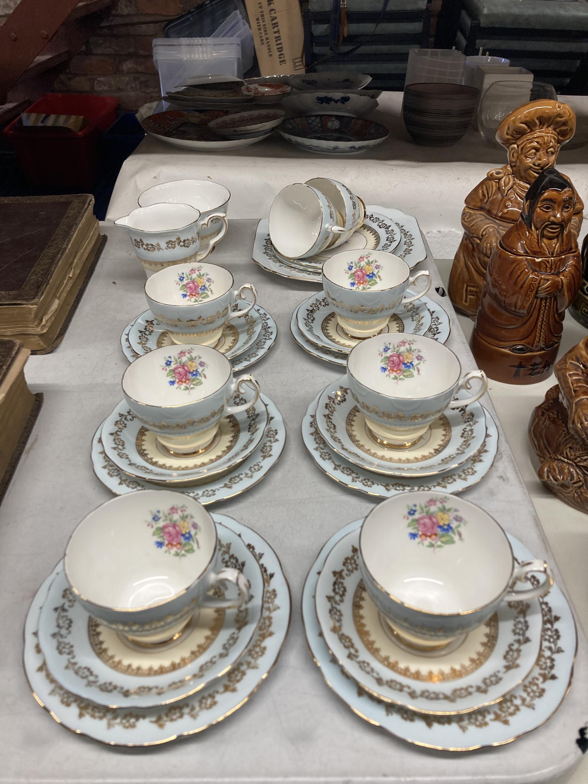 A GLADSTONE CHINA TEASET IN PALE BLUE WITH FLORAL AND GILT DECORATION TO INCLUDE CAKE PLATE, CREAM