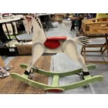 A VINTAGE WOODEN CHILD'S METAMORPHIC ROCKING HORSE - IT CAN BE USED AS A ROCKER OR HAS WHEELS THAT