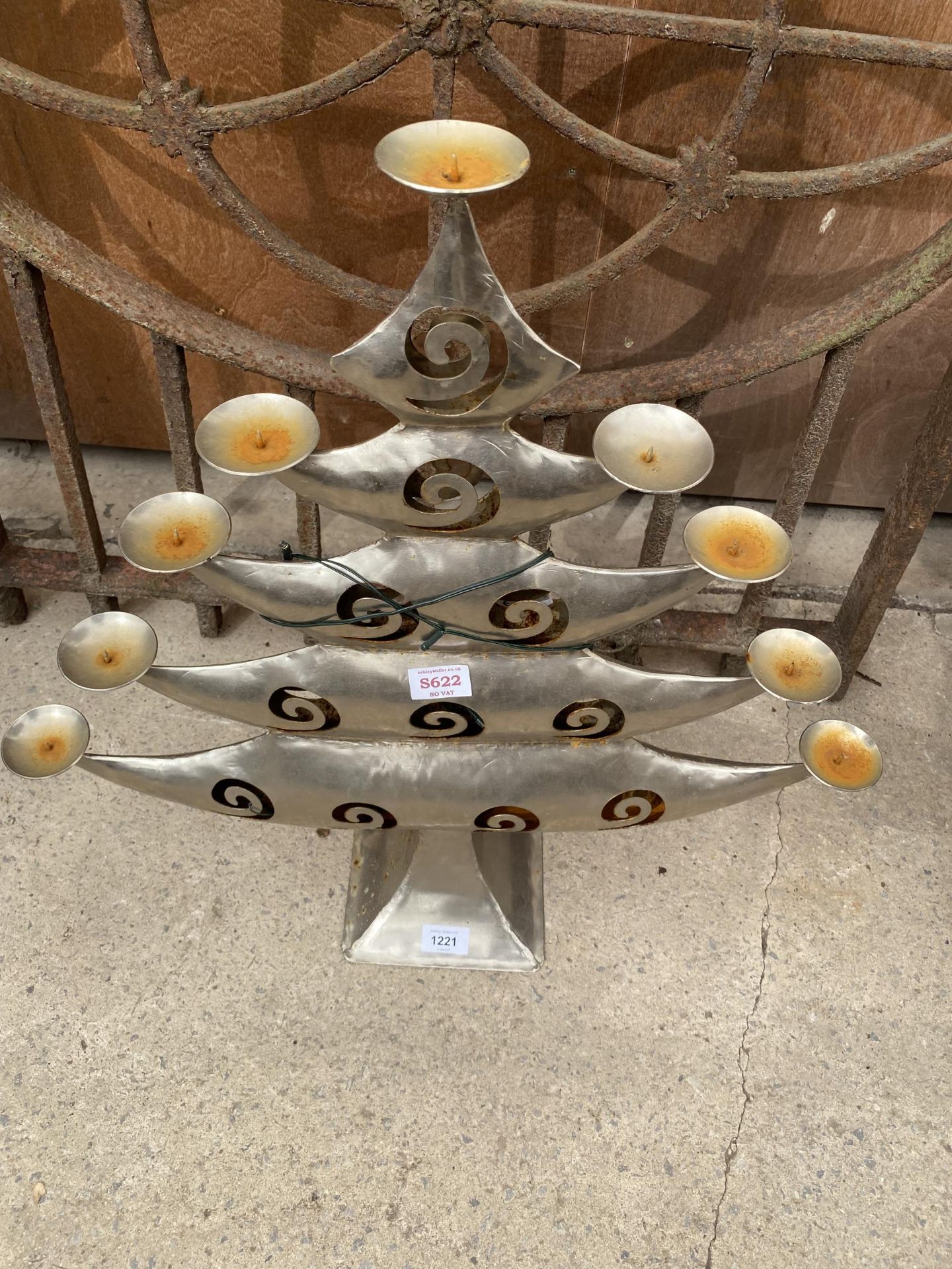 A METAL CHRISTMAS TREE CANDLE HOLDER
