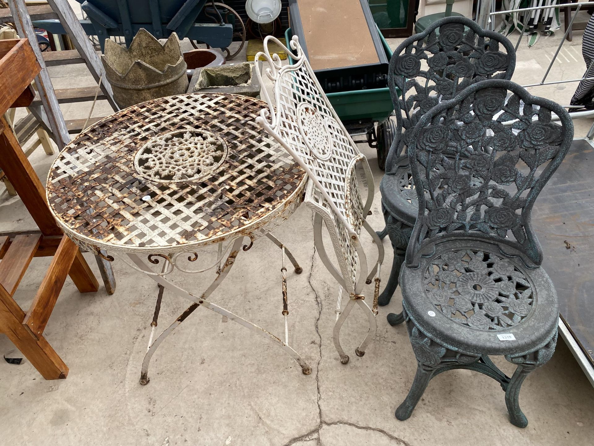 A METAL FOLDING BISTRO TABLE AND CHAIR AND A FURTHER TWO PLASTIC GARDEN CHAIRS