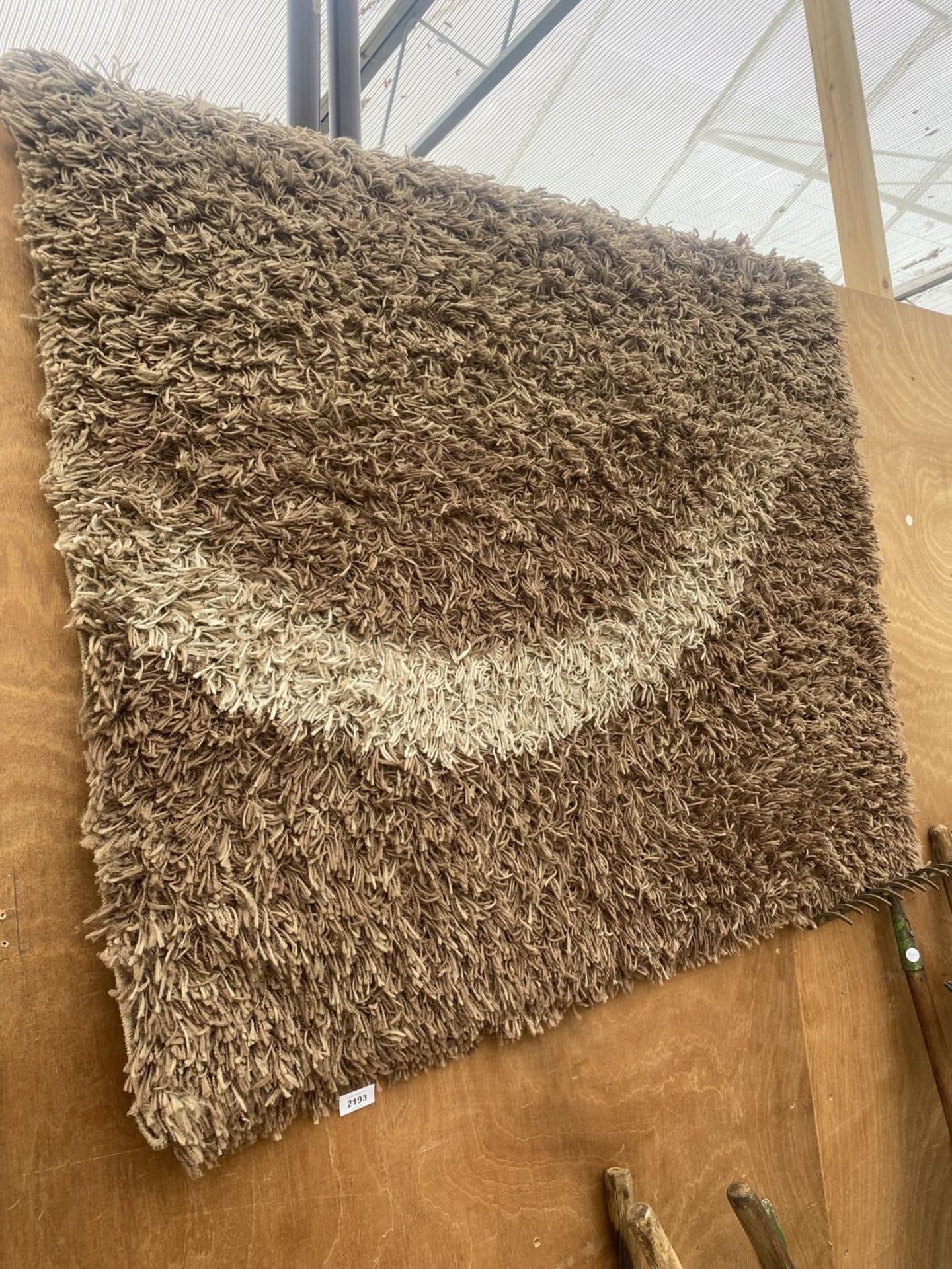 A MODERN BROWN RUG