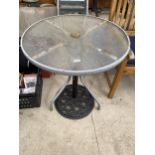 A GLASS TOPPED BISTRO TABLE AND A CAST IRON PARASOL BASE