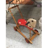 A VINTAGE WOODEN HORSE WITH WHEELS AND A HANDLE
