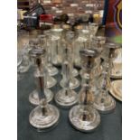 A QUANTITY OF SILVER COLOURED CANDLESTICKS - 11 IN TOTAL PLUS FOUR SILVER COLOURED GLASS VASES