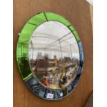 AN ART DECO STYLE MIRROR WITH BLUE AND GREEN OUTER FRAME