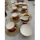 A QUANTITY OF AYNSLEY CHINA TEAWARE IN CRIMSON AND GOLD TO INCLUDE TRIOS, CREAM JUG, SUGAR BOWL