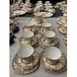 A BONE CHINA TEASET WHITE WITH GILT DECORATION TO INCLUDE CUPS, SAUCERS, SIDE PLATES, CAKE PLATE,