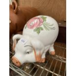 A LARGE CERAMIC PIG MONEY BOX WITH STOPPER