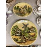 TWO CERAMIC 3-D WALL PLAQUES WITH SCENES OF RURAL VILLAGES