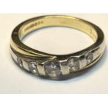 A 14 CARAT GOLD RING WITH FIVE IN LINE CUBIC ZIRCONIAS SIZE N/0