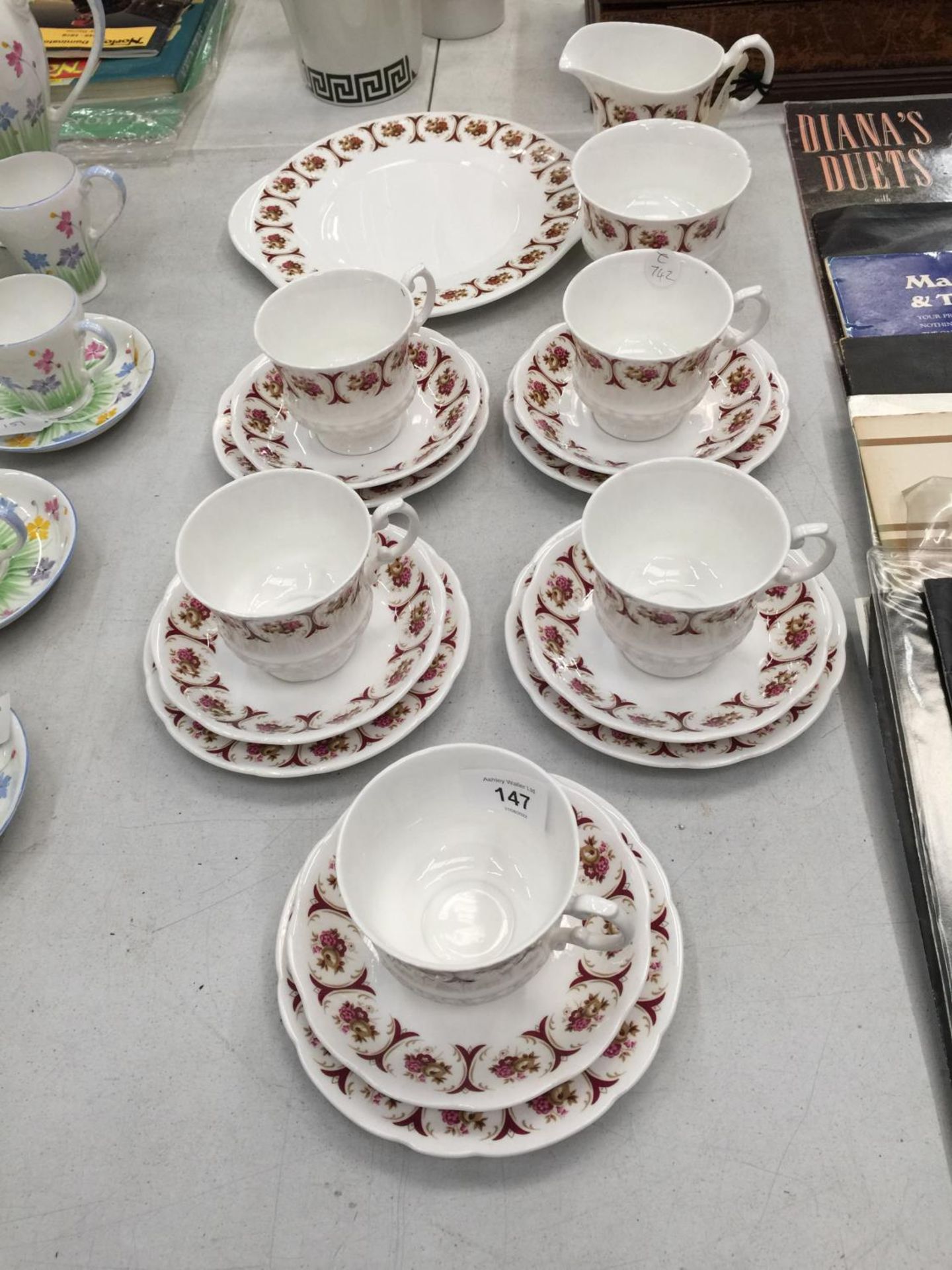 A CHINA PART TEASET 'DIANE' TO INCLUDE CUPS, SAUCERS, PLATES, CREAM JUG AND SUGAR BOWL