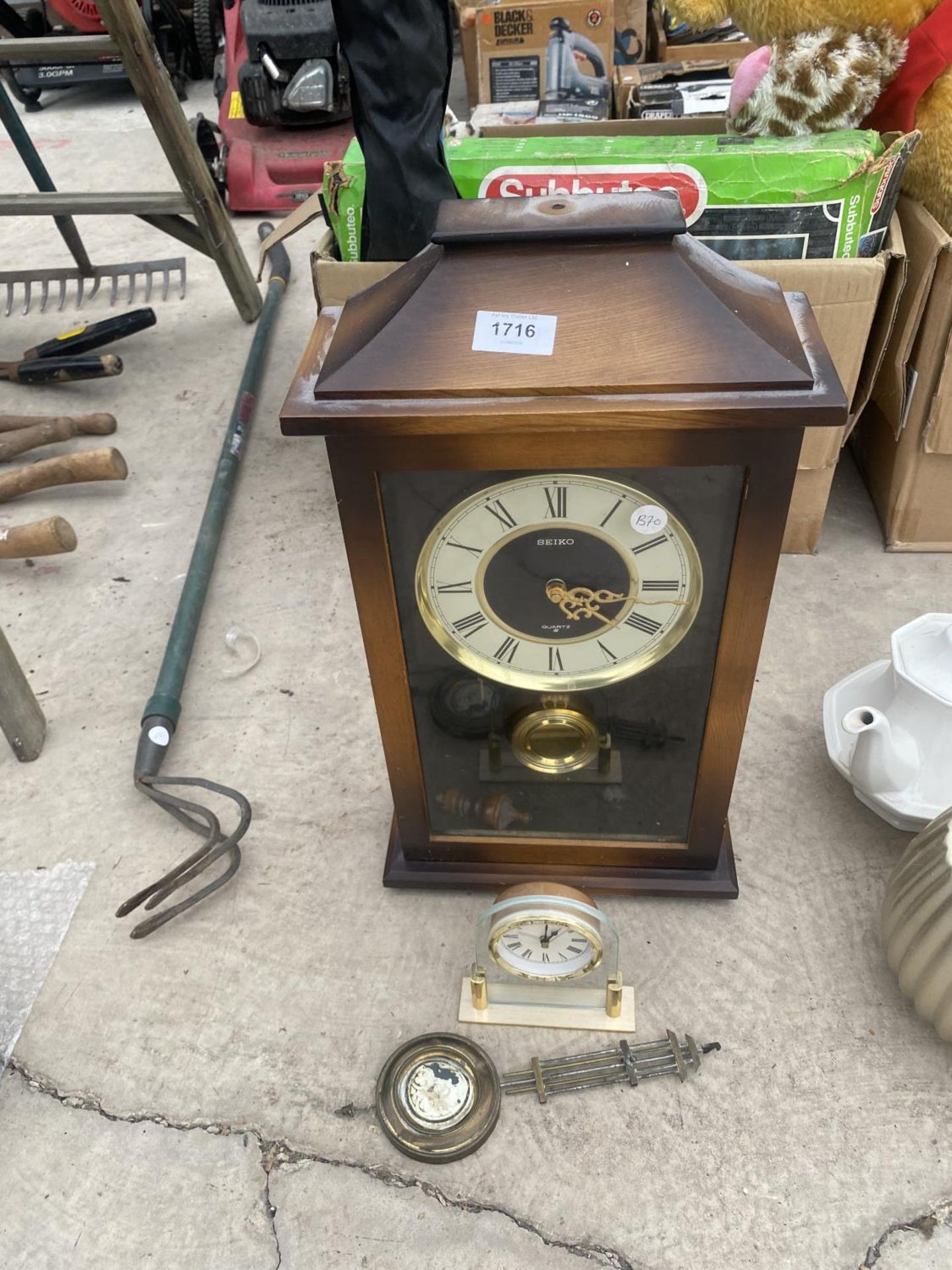 A DECORATIVE WALL CLOCK AND A FURTHER SMALL MANTLE CLOCK