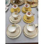 SIX BONE CHINA TRIOS WITH ROSE DECORATION AND GILDING TO THE RIMS AND HANDLES