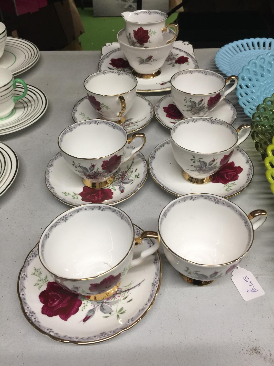A ROYAL STAFFORD 'ROSES TO REMEMBER' TEASET TO INCLUDE CREAM JUG, SUGAR BOWL, CAKE PLATE, SIX CUPS