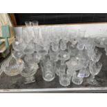 A LARGE ASSORTMENT OF GLASS WARE TO INCLUDE VASES, WINE GLASSES AND SHERRY GLASSES ETC