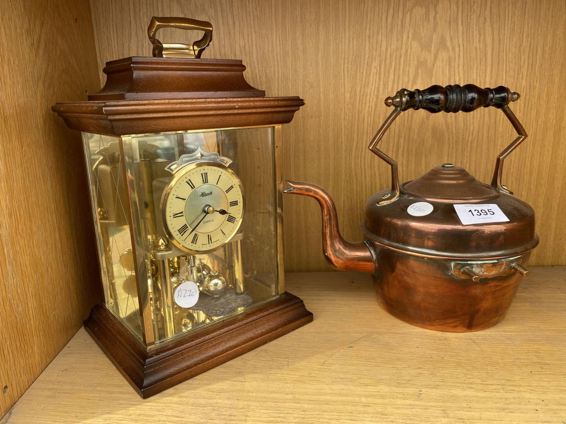 A COPPER KETTLE AND A MANTLE CLOCK