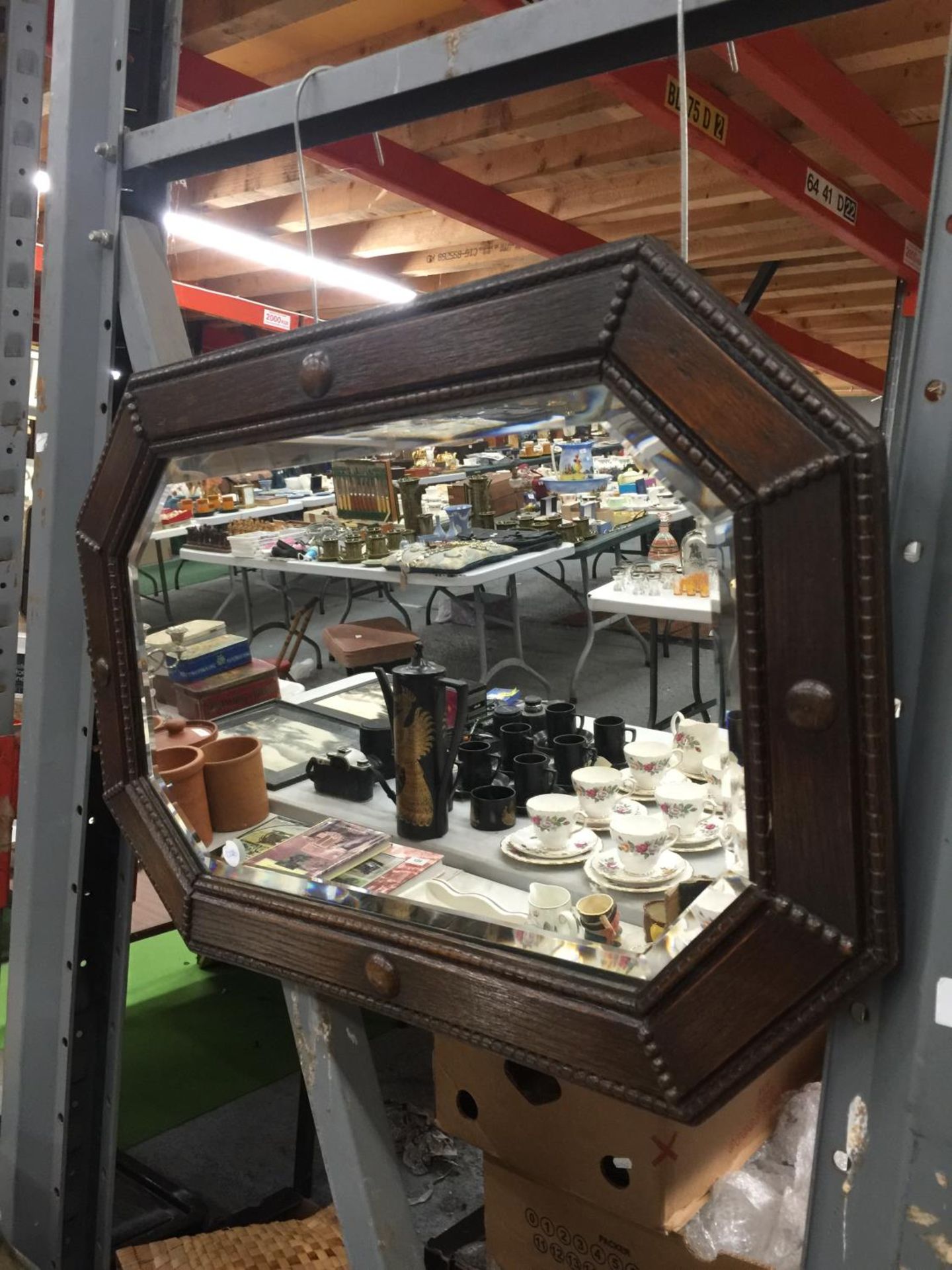 AN ARTS AND CRAFTS STYLE VINTAGE WALL MIRROR IN AN OCTAGONAL SHAPE WITHBEVELLED GLASS AND MAHOGANY