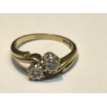 A 9 CARAT GOLD RING WITH TWO DIAMONDS ON A TWIST DESIGN SIZE M