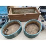 A WOODEN TROUGH PLANTER AND A PAIR OF RECONSTITUTED STONE PLANTERS