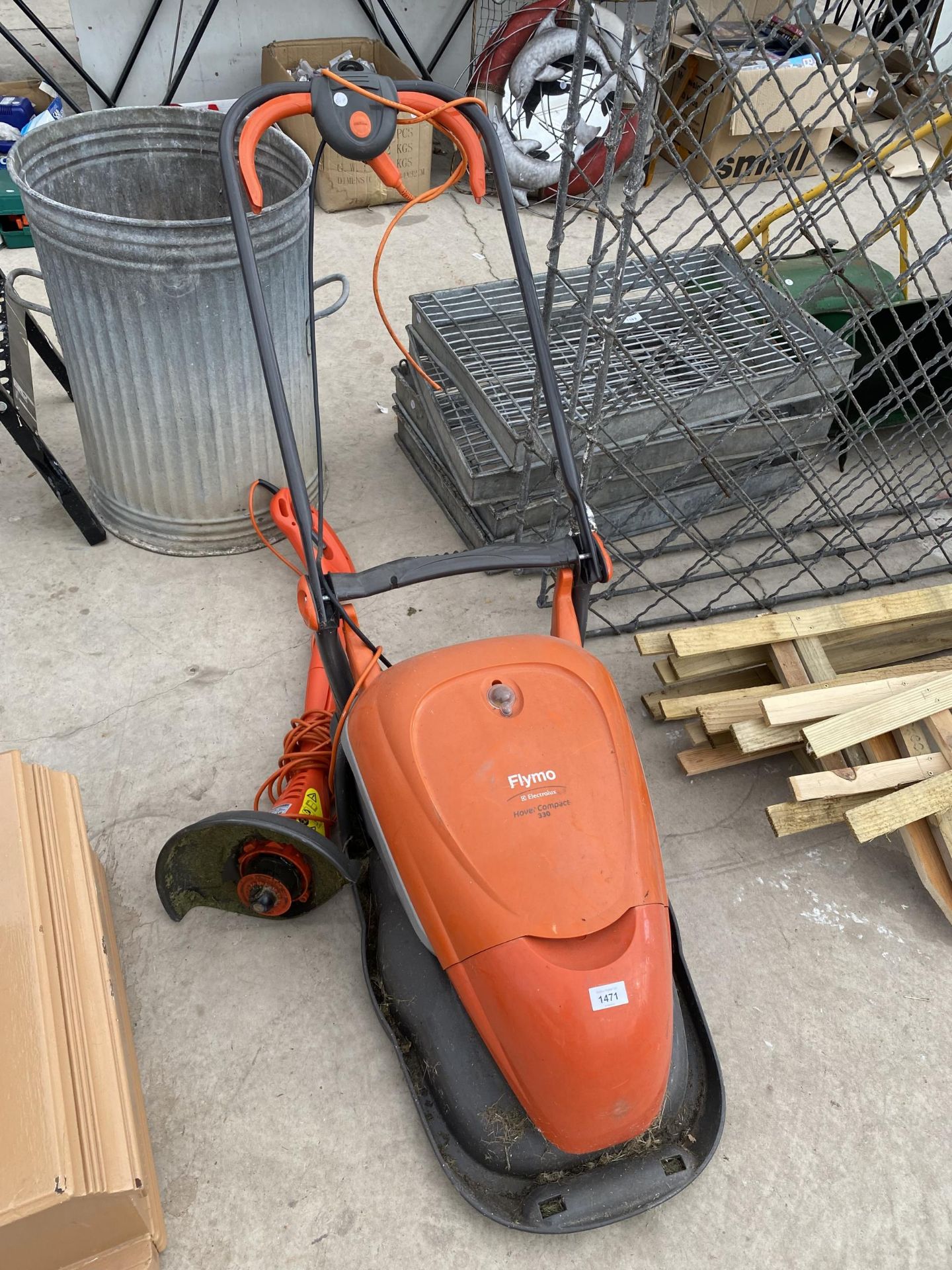 A FLYMO ELECTRIC LAWN MOWER AND AN ELECTRIC GRASS STRIMMER