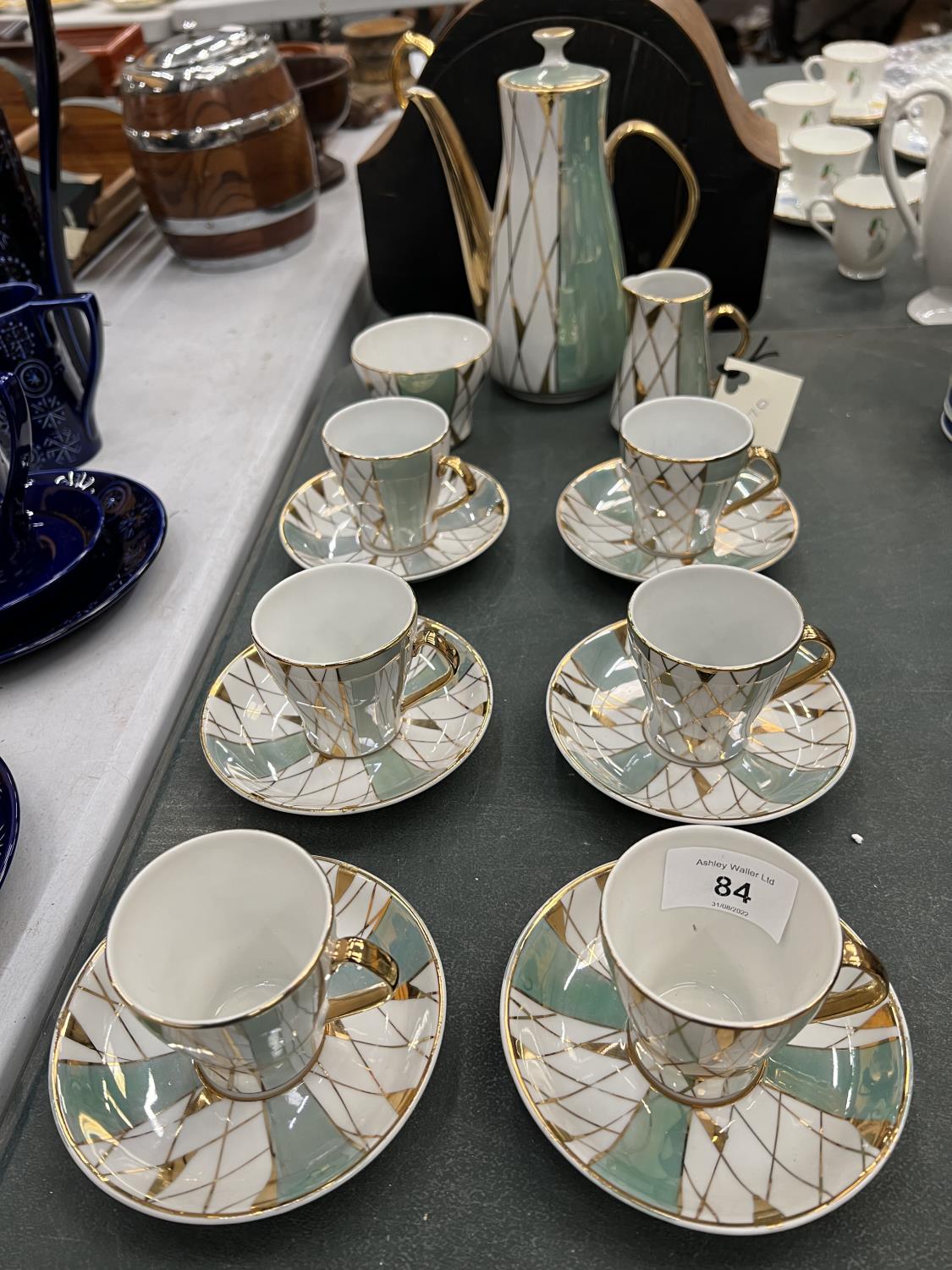 A LUSTRE COFFEE SET IN A HARLEQUIN PATTERN TO INCLUDE COFFEE POT, CREAM JUG, SUGAR BOWL, CUPS AND