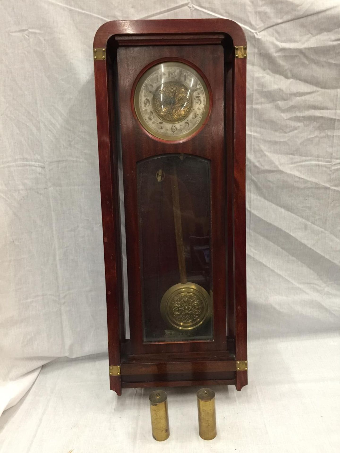 AN ART NOUVEAU STYLE MAHOGANY CASED WALL CLOCK WITH BRASS AND SILVERED DIAL