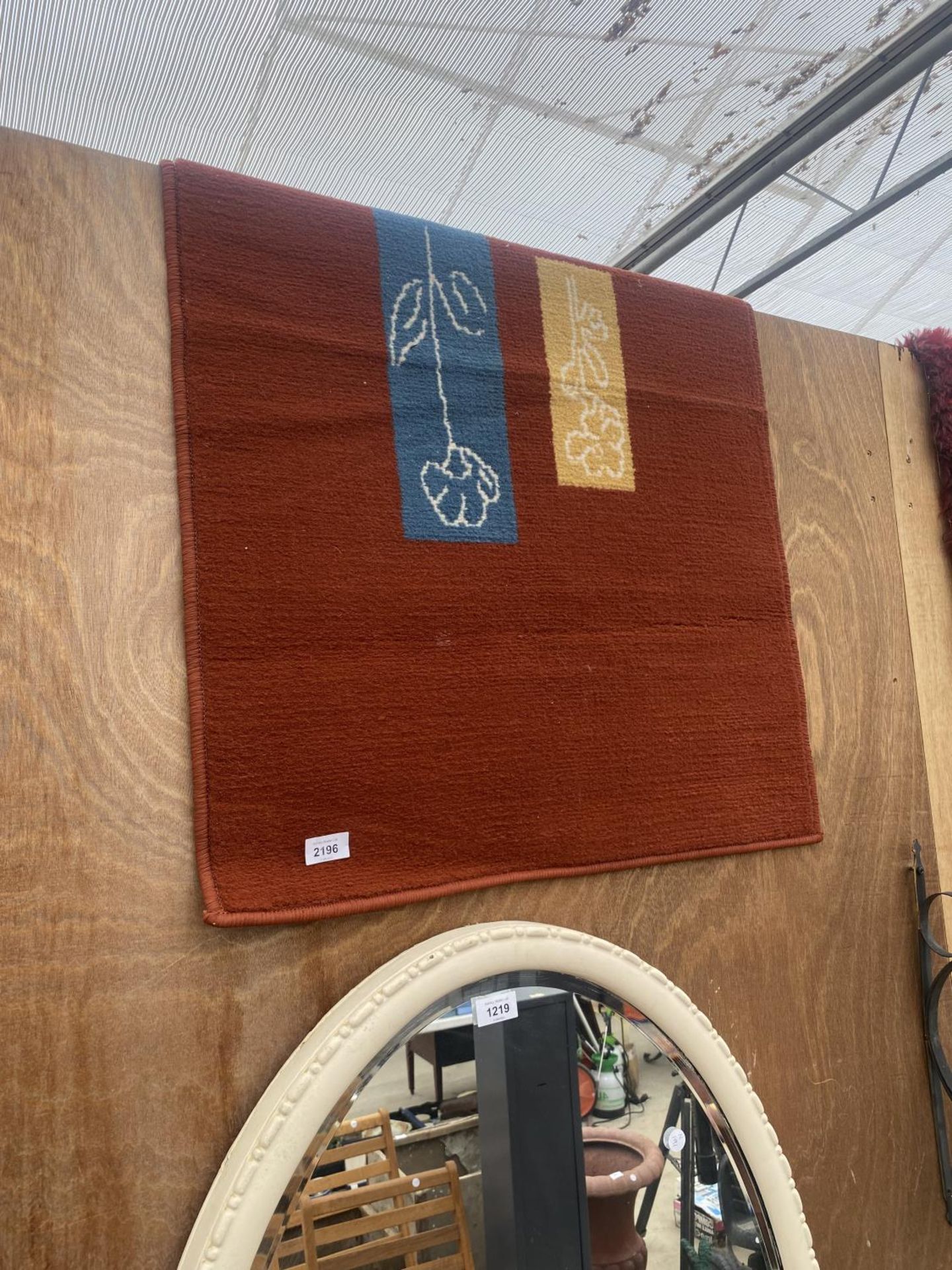 AN ORANGE RUG WITH PATTERNED DETAIL