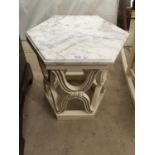A HEXAGONAL TABLE WITH MARBLE TOP