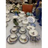 A COLLECTION OF CERAMIC ITEMS TO INCLUDE MINI CUPS AND SAUCERS, SILVER WEDDING CUPS, CRUET SET,