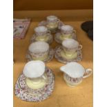 A WINDSOR CHINA TEASET IN A YELLOW AND FLORAL PATTERN WITH GILT RIMS TO INCLUDE A CAKE PLATE,