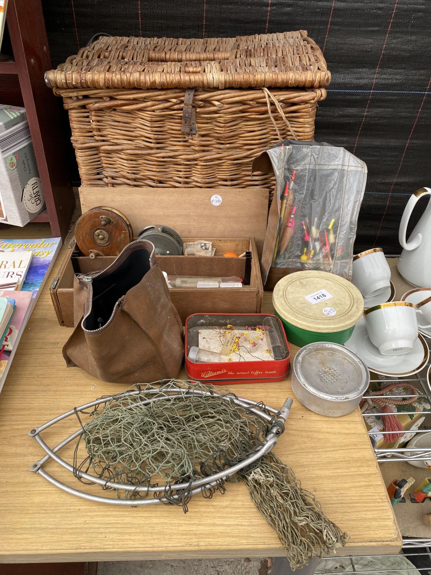 AN ASSORTMENT OF VINTAGE FISHING TACKLE TO INCLUDE A WICKER TACKLE BASKET, REELS AND FLOATS ETC