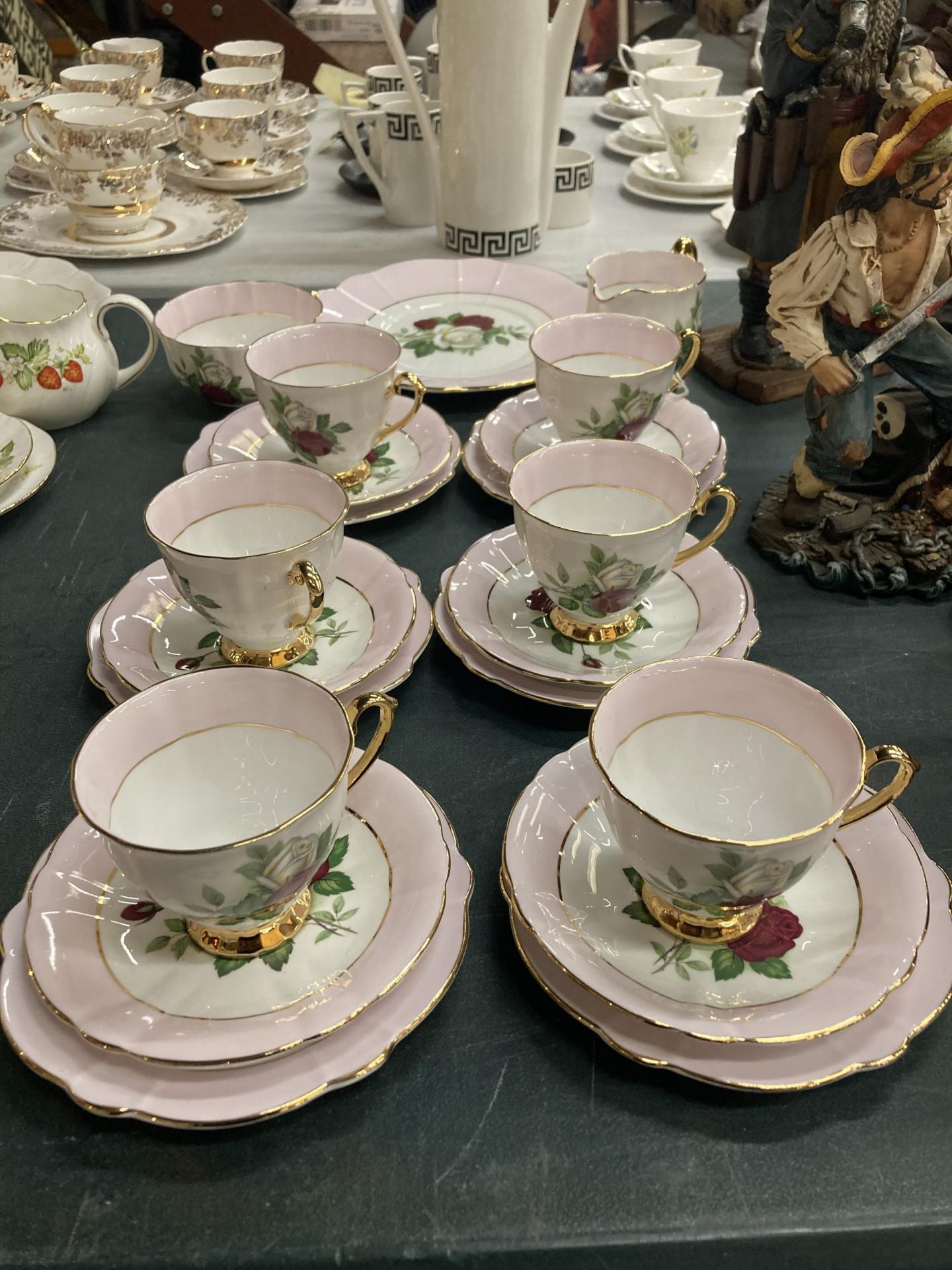 A WINDSOR BONE CHINA TEASET WITH PINK AND ROSE DECORATION AND GILDING TO RIMS AND HANDLES TO INCLUDE