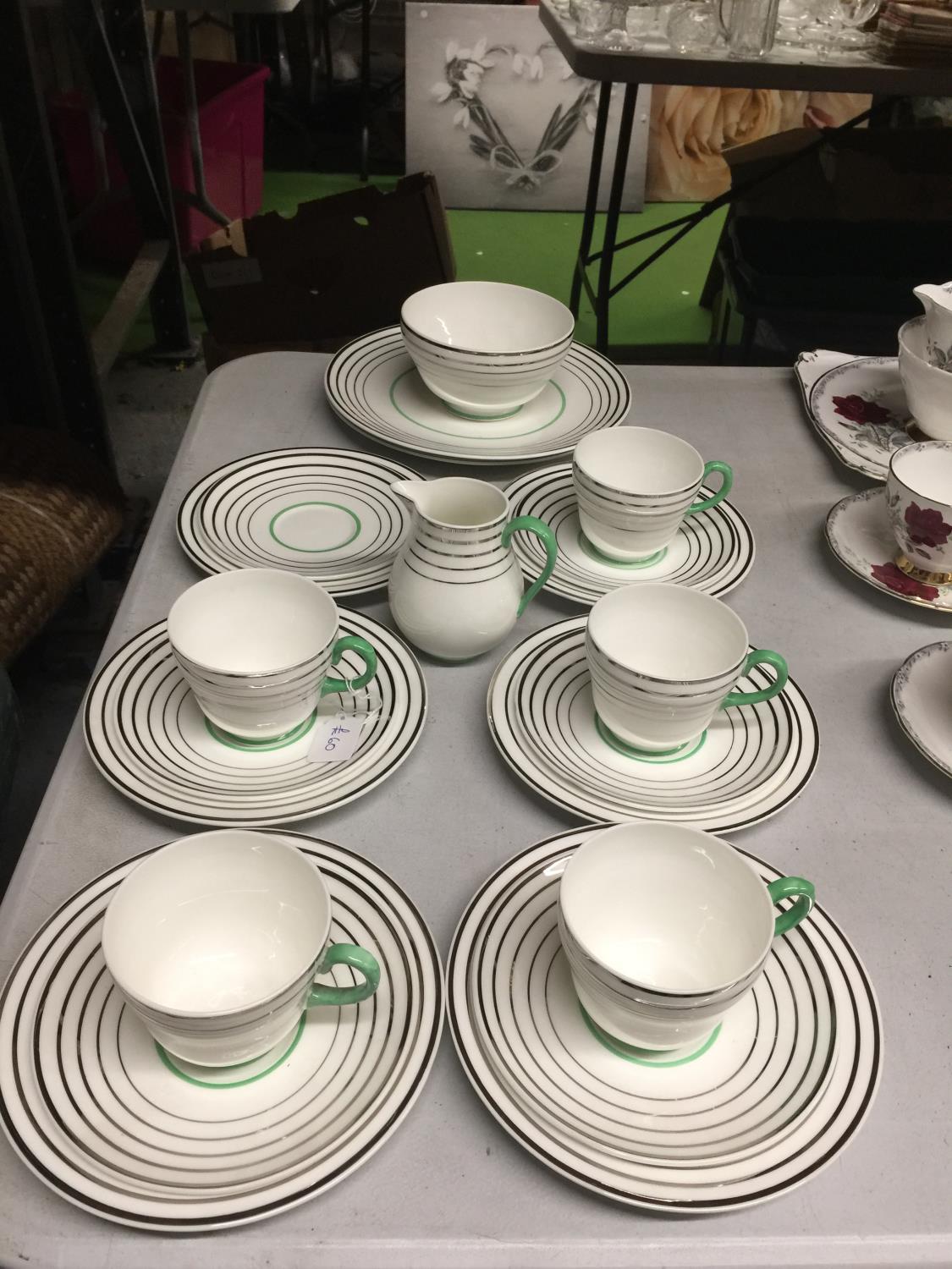 A WEDGWOOD BONE CHINA TEASET IN A SILVER AND GREEN COLOURED CIRCULAR DESIGN TO INCLUDE CAKE PLATES