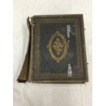 A VINTAGE BROWN'S SELF INTERPRETING BIBLE WITH BRASS EDGES